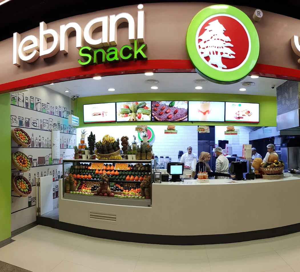 Lebnani Snack curved food-court counter beneath illuminated bilingual signage