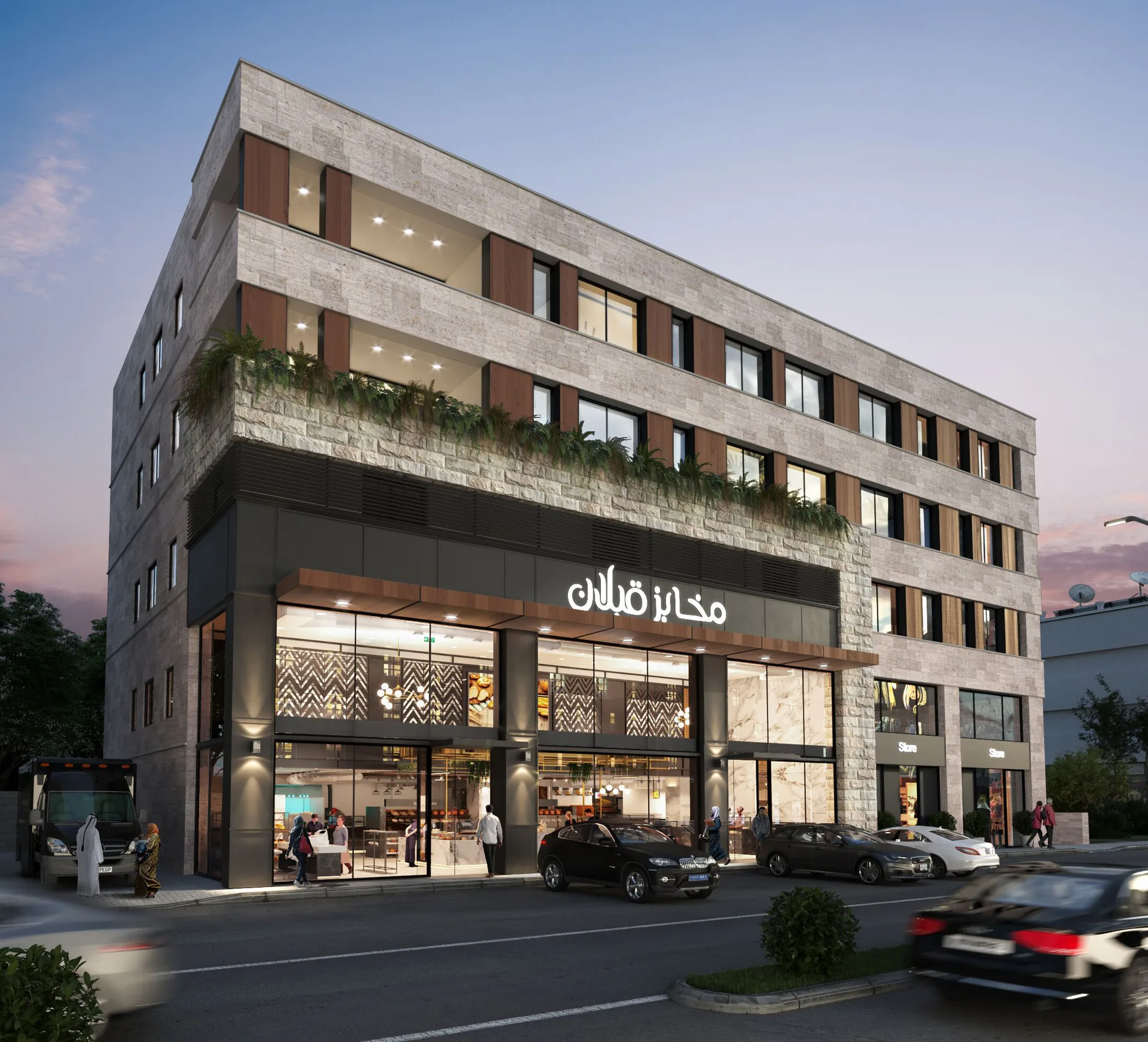 Qabalan Office Building & Bakery exterior at dusk, with glazed storefronts beneath stone-clad offices